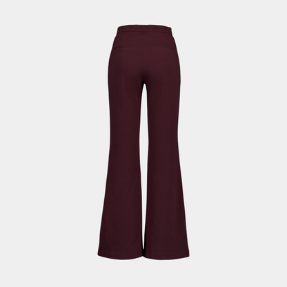 Burgundy flared pants on a light gray background