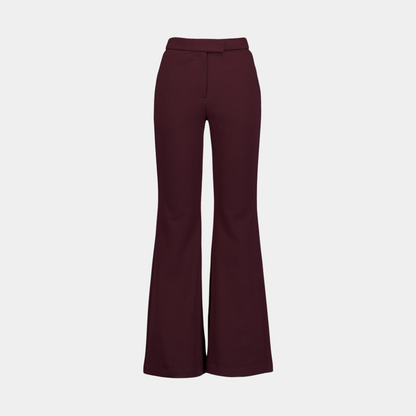 Burgundy flared pants on a light gray background